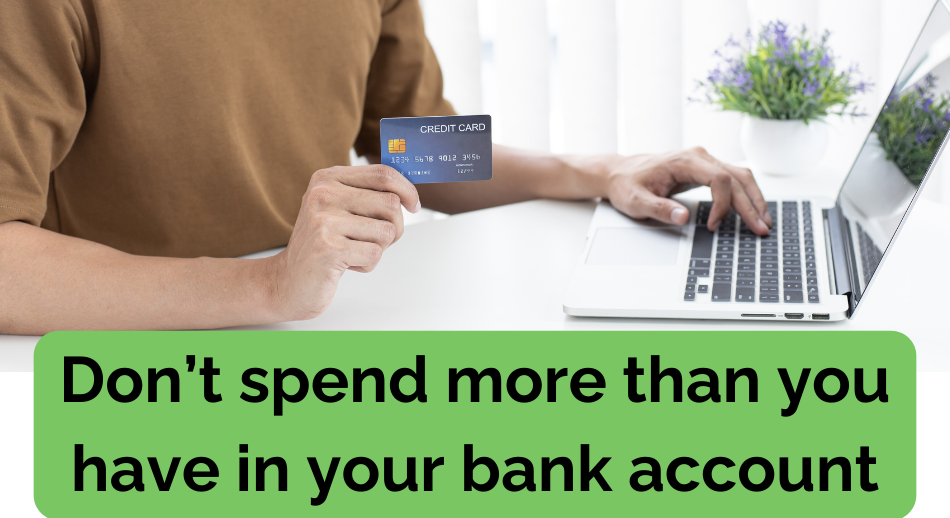 Text with Don't Spend more than you have in your bank account with an image of a man holding a credit card while at his computer.